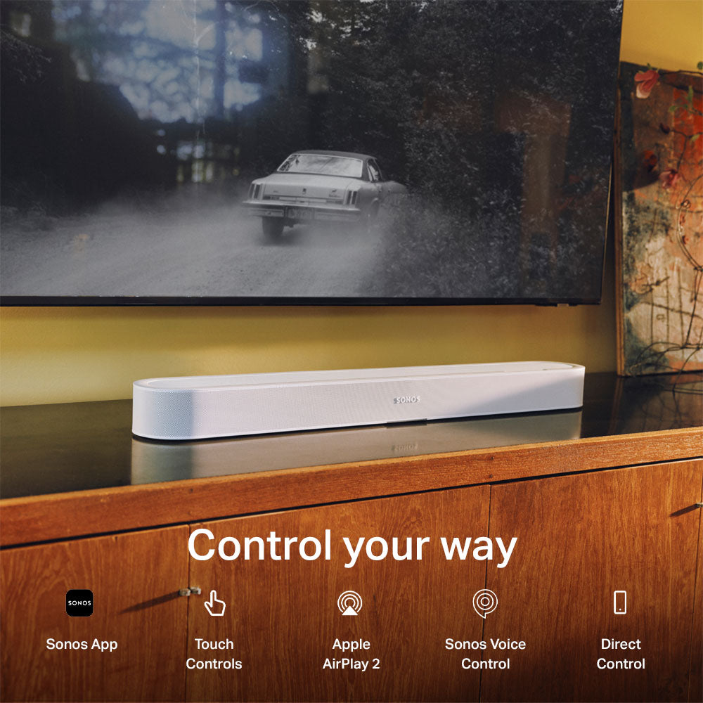 A white Sonos soundbar sits on a wooden media console beneath a TV, with the text 'Control your way' and feature icons for Sonos App, Touch Controls, Apple AirPlay 2, Sonos Voice Control, and Direct Control.